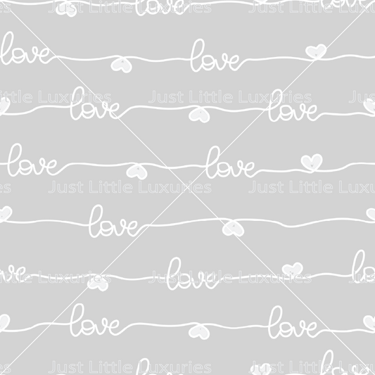 White “love” script pattern on a light grey background digital edible image